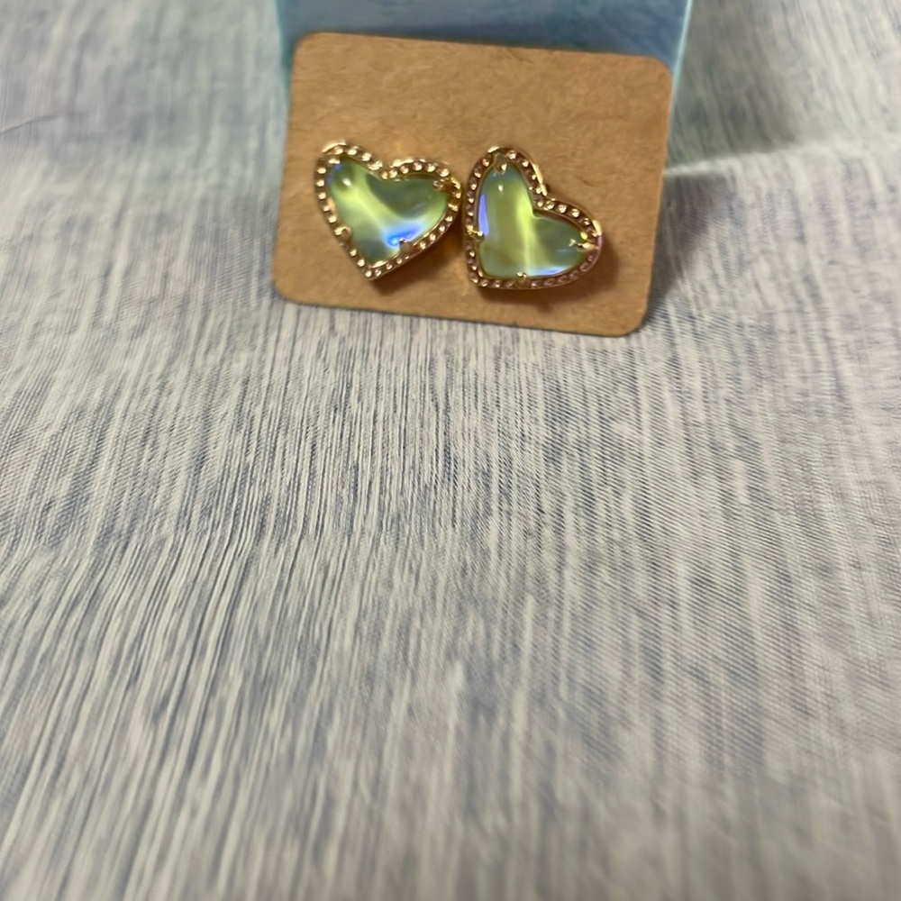 Gold heart shaped earrings with green stones